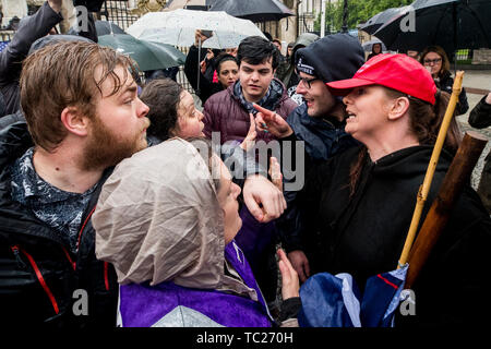 Former Belfast Councillor Jolene Bunting (right) with her partner Wayne Cummings (second from right) speaking with a stewards during a corner protest at a 'Stop Trumpism' rally hosted by ExAct: Expat Action Group NI, at Belfast City Hall. Stock Photo