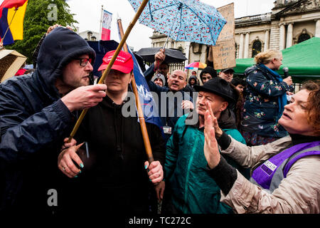 RETRANSMITTED CORRECTING SPELLING OF CUMMINGS Wayne Cummings (left) with his partner former Belfast Councillor Jolene Bunting (second from left) speaking with a steward during a corner protest at a 'Stop Trumpism' rally hosted by ExAct: Expat Action Group NI, at Belfast City Hall. Stock Photo