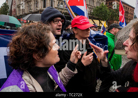 RETRANSMITTED CORRECTING SPELLING OF CUMMINGS Wayne Cummings (second from left) with his partner former Belfast Councillor Jolene Bunting (second from right) speaking with a steward and a person who attend the gathering during a corner protest at a 'Stop Trumpism' rally hosted by ExAct: Expat Action Group NI, at Belfast City Hall. Stock Photo