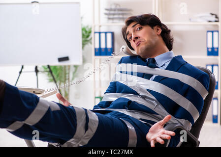 Young tied male employee in the office Stock Photo