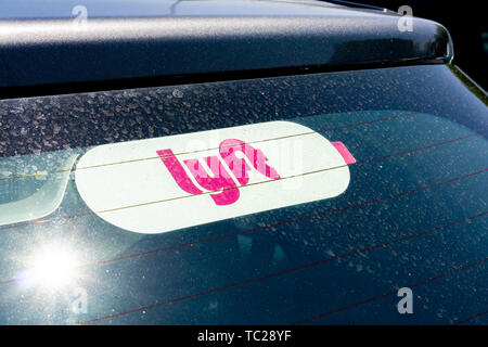 May 30, 2019 Milpitas / CA / USA - Lyft sticker on the rear window of a vehicle offering rides