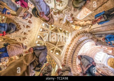 Low angle view of visitors below the dome of the Chapel of Villaviciosa, a 15th century Christian work inside the moorish Mosque of Cordoba, Spain. Stock Photo