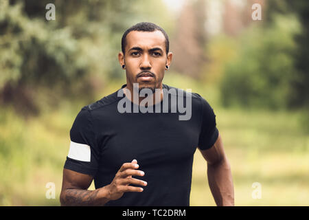 Morning Running. African-American Runner Jogging In Park Stock Photo