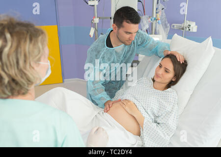 pregnant woman giving birth in hospital Stock Photo