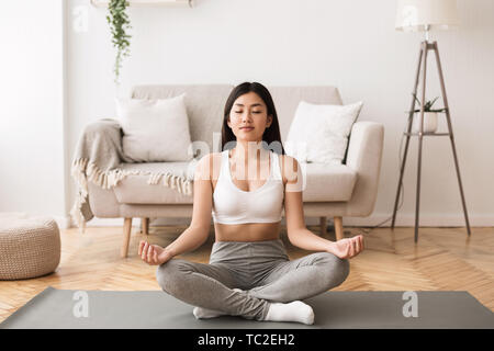 Time For Yoga. Asian Girl Exercising And Meditating Stock Photo