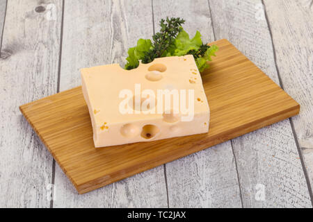 Maasdam cheese brick with thyme branch Stock Photo