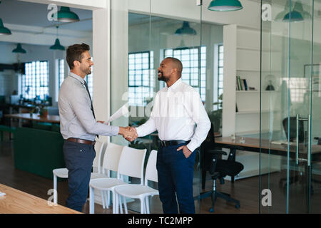 Manager shaking hands with a job applicant after an interview Stock Photo