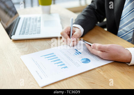 businessman checking financial reports on table Stock Photo