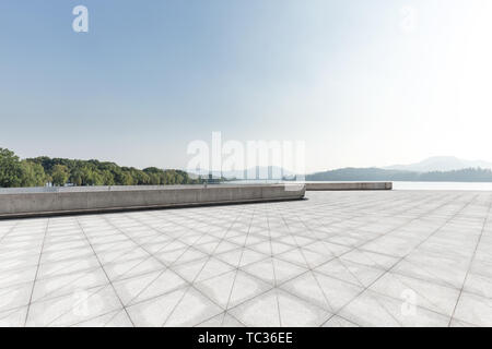 empty marble floor with beautiful lake in blue sky Stock Photo