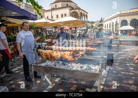 April 28, 2019. Athens, Greece. Kokorec and lamb are grilling on skewers over charcoal fire. Greek Easter custom, Monastiraki Stock Photo