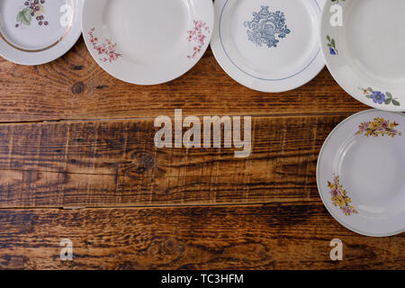 Empty plates on wooden background. Frame of dishes. Flat lay. Place under your text. Cutlery. Stock Photo