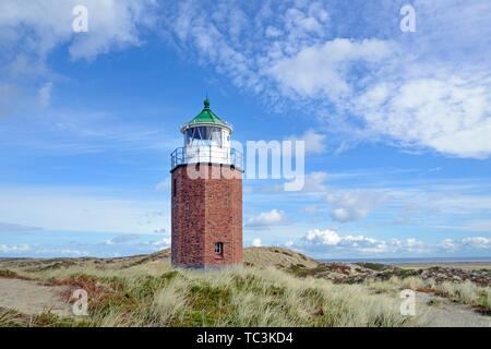 Small lighthouse in dunes, cross light red cliff with cloudy sky, Kampen, Sylt, North Frisian Islands, North Frisia, Schleswig-Holstein, Germany Stock Photo