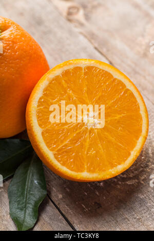 Fresh oranges on the table, one and half oranges on the table Stock Photo