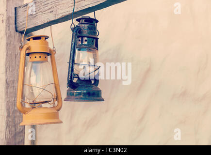 Kerosene lamp or lantern weighs on a wooden beam. horizontally Stock Photo