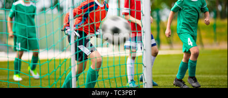 Young Goalkeeper Saves. Football Horizontal Background. Junior Soccer Goalkeeper Saving on a Goal Stock Photo