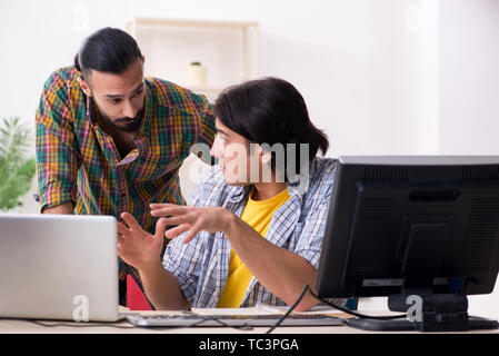Two it specialists working in the office Stock Photo