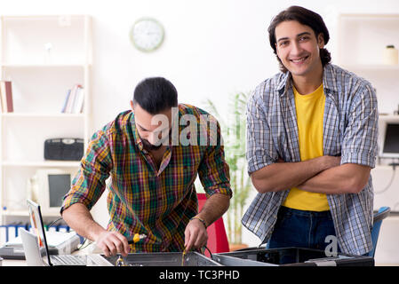 IT engineers working on hardware issue Stock Photo