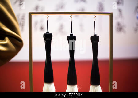 hanging calligraphy brushes on steel frame Stock Photo