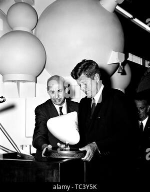 President John F Kennedy (1917 - 1963) and Dr Robert R Gilruth (1913 - 2000) look at a small model of the Apollo Command Module, September 12, 1962. Image courtesy National Aeronautics and Space Administration (NASA). ()