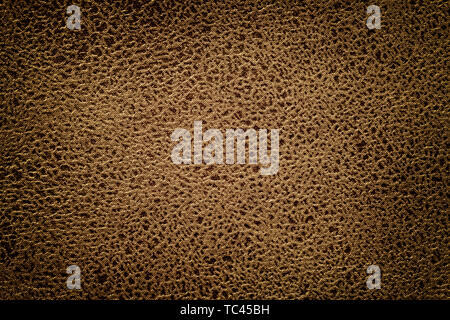 Dark brown background from a soft upholstery textile material, closeup. Matte bronze velvet fabric with natural texture. Cloth backdrop with vignette Stock Photo