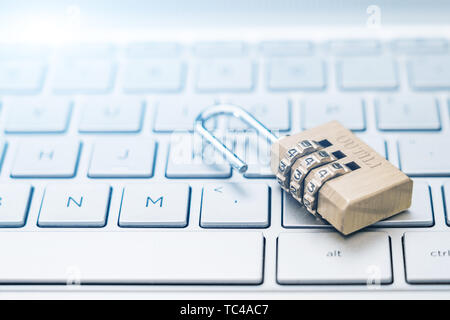 An open lock on a computer keyboard. Stock Photo