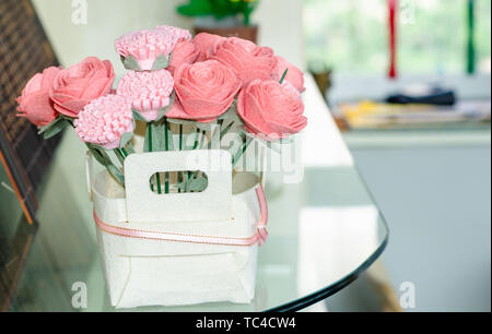 A flower arrangement on a glass table. Stock Photo