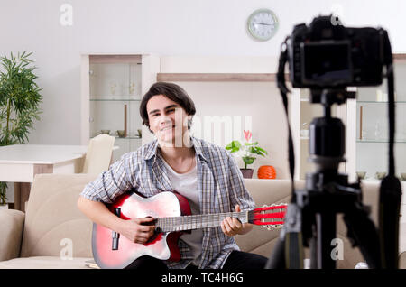 Young guitar player recording video for his blog Stock Photo