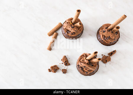 Tasty chocolate cupcakes on light table Stock Photo