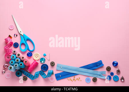 Set of sewing threads and accessories on color background Stock Photo