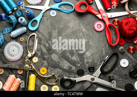 Frame made of sewing threads and accessories on grunge background Stock Photo