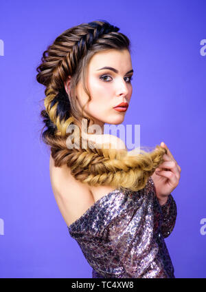 Beautiful young woman with modern hairstyle. Beauty salon hairdresser art. Girl makeup face braided long hair. French braid. Professional hair care and creating hairstyle. Braided hairstyle. Stock Photo