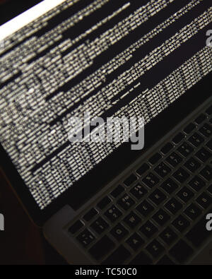 Hacking server. Close up photo of laptop screen with binary code. Cyber attack. Cyber security. Safety concept Stock Photo
