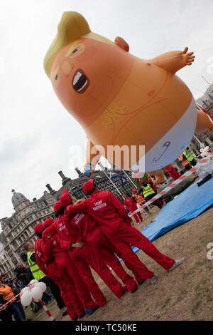 The Trump Baby and babysitters, a six metre high inflatable blimp flying above Westminster prior to protests against the state visit of US President Donald Trump on 4th June 2019 in London, United Kingdom. Organisers Together Against Trump which is a collaboration between the Stop Trump Coalition and Stand Up To Trump, have organised a carnival of resistance, a national demonstration to protest against President Trump’s policies and politics during his official UK visit. Stock Photo