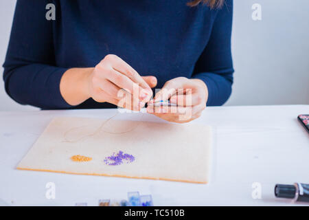 Designer making handmade brooch Stock Photo