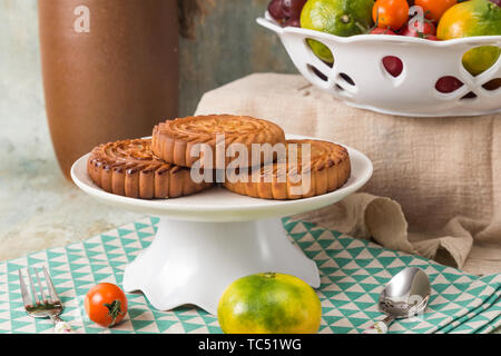 Moon cakes and fruit on the table Stock Photo