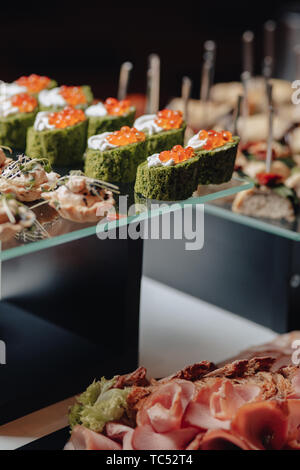 delicious festive buffet with canapés and different delicious meals salted and sweet Stock Photo