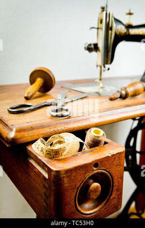 Vintage tailor's tools on old sewing machine, old fashioned tailoring equipment Stock Photo