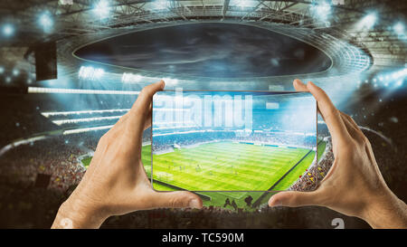 Watch a live sports event on your mobile Stock Photo