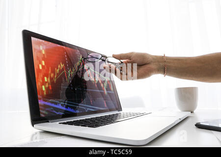 businessman shows the screen on laptop the graph of growth Stock Photo