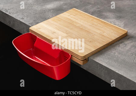 Wood Cutting Board with Waste Container on Stone Kitchen Table Stock Photo