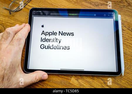 Paris, France - Mar 27, 2019: POV personal perspective on Apple News webpage seen on modern iPad Pro tablet featuring Identity guidelines Stock Photo