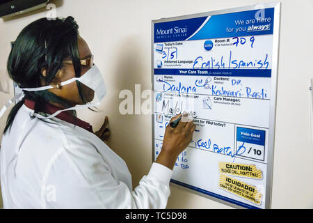 Miami Beach Florida,Mount Mt. Sinai Medical Center centre hospital,medical patient room,Black woman female women,nurse care technician,writing,FL19033 Stock Photo