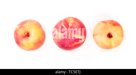 Vibrant organic flat saturn peaches, shot from the top on a white background Stock Photo