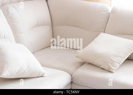 Empty white corner sofa with pillows Stock Photo