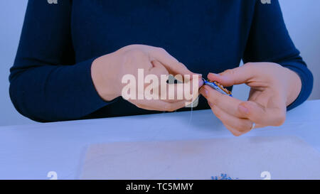 Designer making handmade brooch Stock Photo