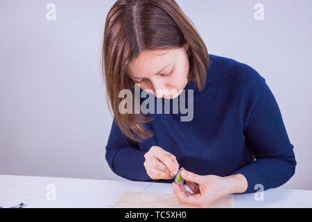 Designer making handmade brooch Stock Photo