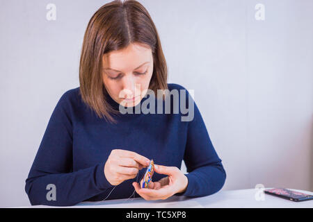 Designer making handmade brooch Stock Photo