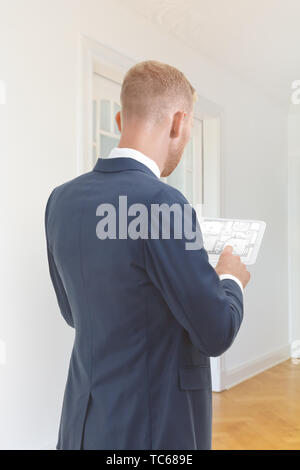 Interior design concept - decorater or architect with the floor plan of an historic building on a tablet computer. Stock Photo