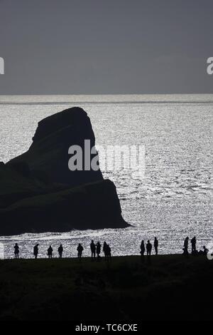 Gower, Swansea, Wales, UK. 5th June 2019. Weather: (note atmospheric distortion) Walkers and  sightseers enjoyed a beautiful sunny evening at National Trust Rhosili (correct,1's') on the Gower peninsula, south Wales. The headland and limestone clifftops afford spectacular views of Rhossili (correct, 2's') Bay and the iconic promontory of Worms Head. Showery conditions are forecast.  Credit: Gareth Llewelyn/Alamy Live News Stock Photo