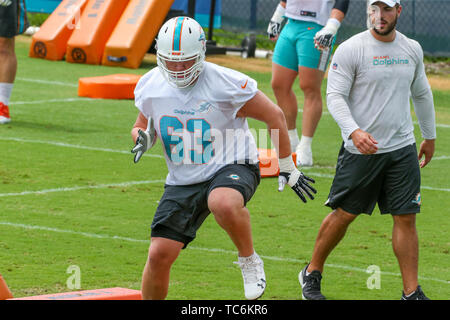 Miami Dolphins offensive lineman Michael Deiter (63) talks with Miami  Dolphins quarterback Teddy Bridgewater on the sidelines during an NFL  football game against the Houston Texans, Sunday, Nov. 27, 2022, in Miami